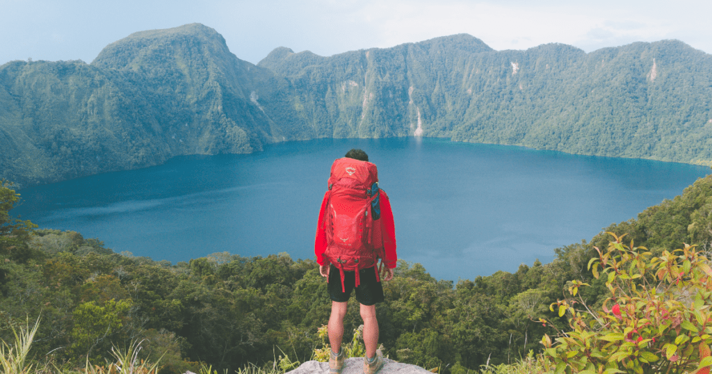 Backpacker looking over lake