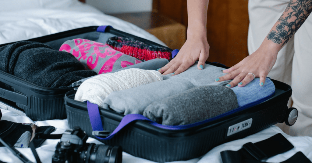 Rolling clothes in suitcase