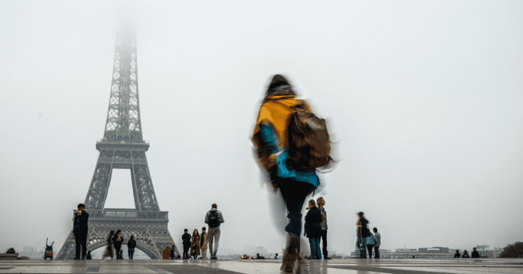 girl in front of cloudy eiffel tower